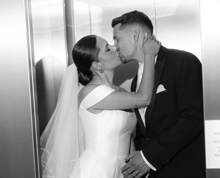 Newlyweds kissing in a lift, black and white