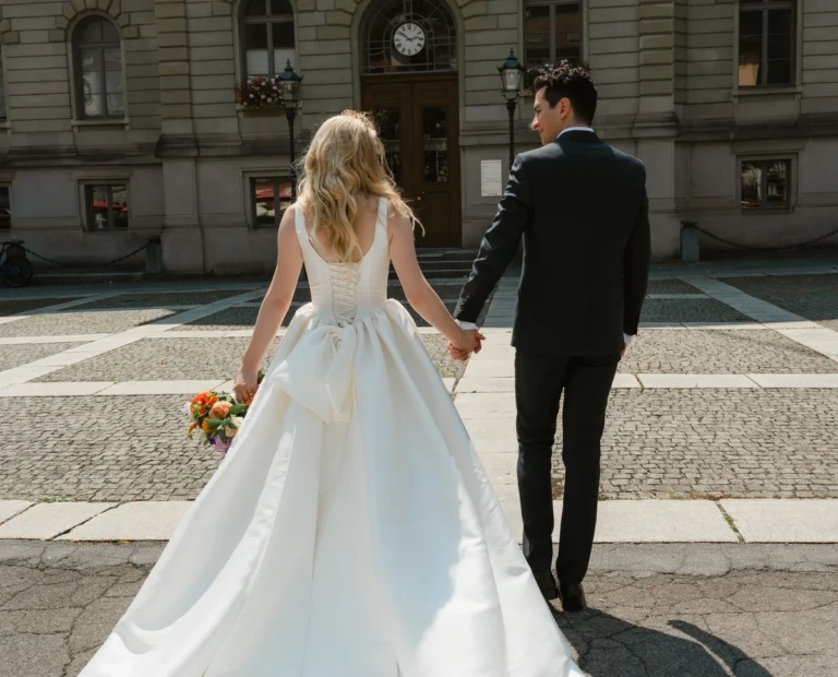 Newlyweds walking away from the town hall hand in hand