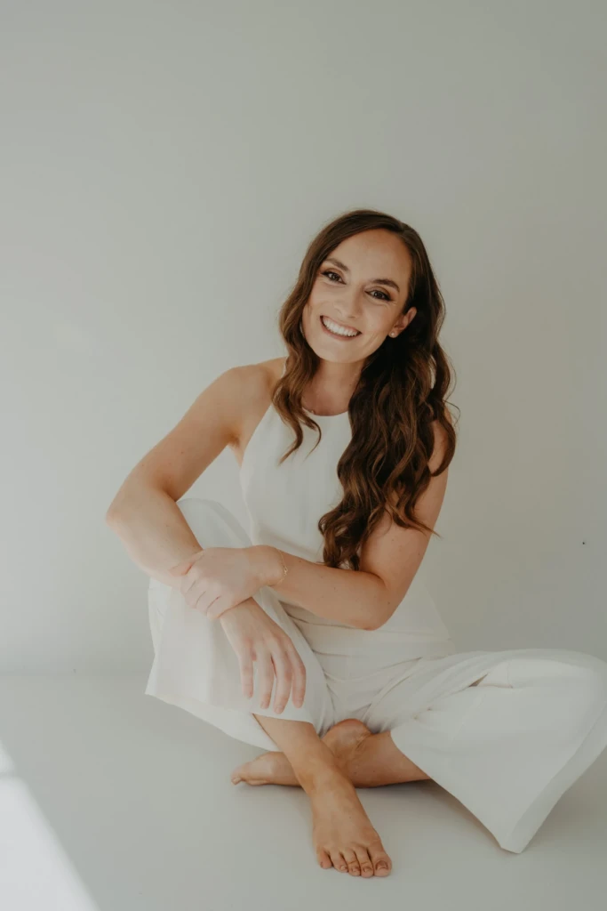 Salome Sommer sitzt lachend im hellen Studio